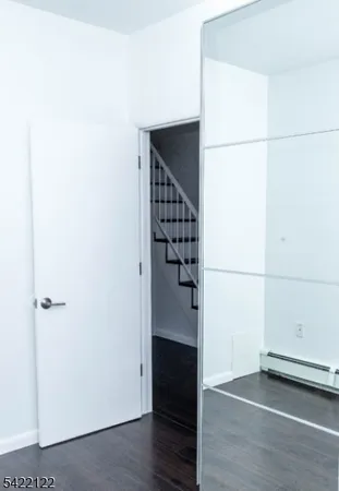 a bathroom with a granite countertop sink and cabinets