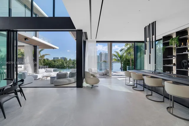 a living room with large windows with outer view