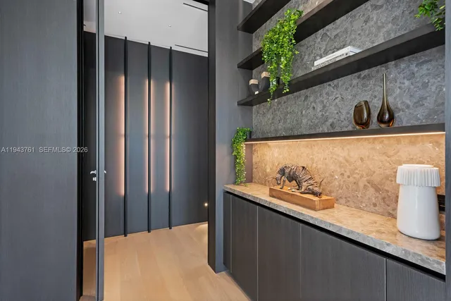 a spacious bedroom with a bed and a flat tv screen on dresser