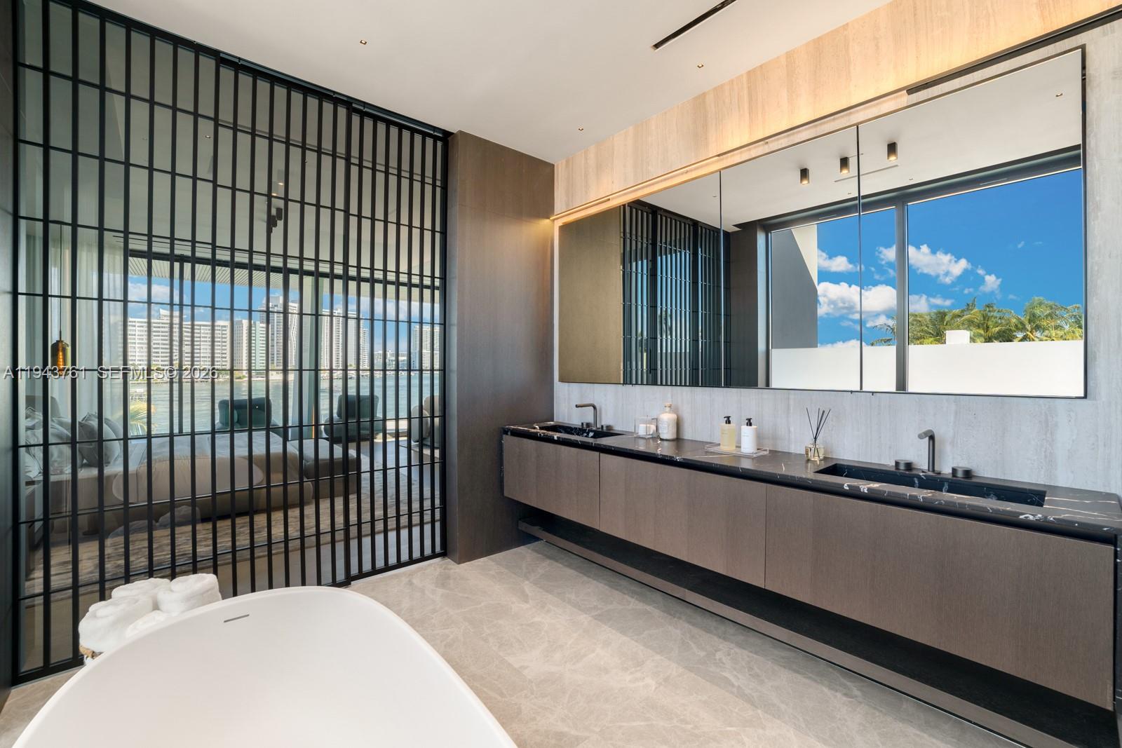 217 East Rivo Alto Drive Miami Beach, FL 33139 - Photo 25 of 87 a bathroom with a sink and a mirror