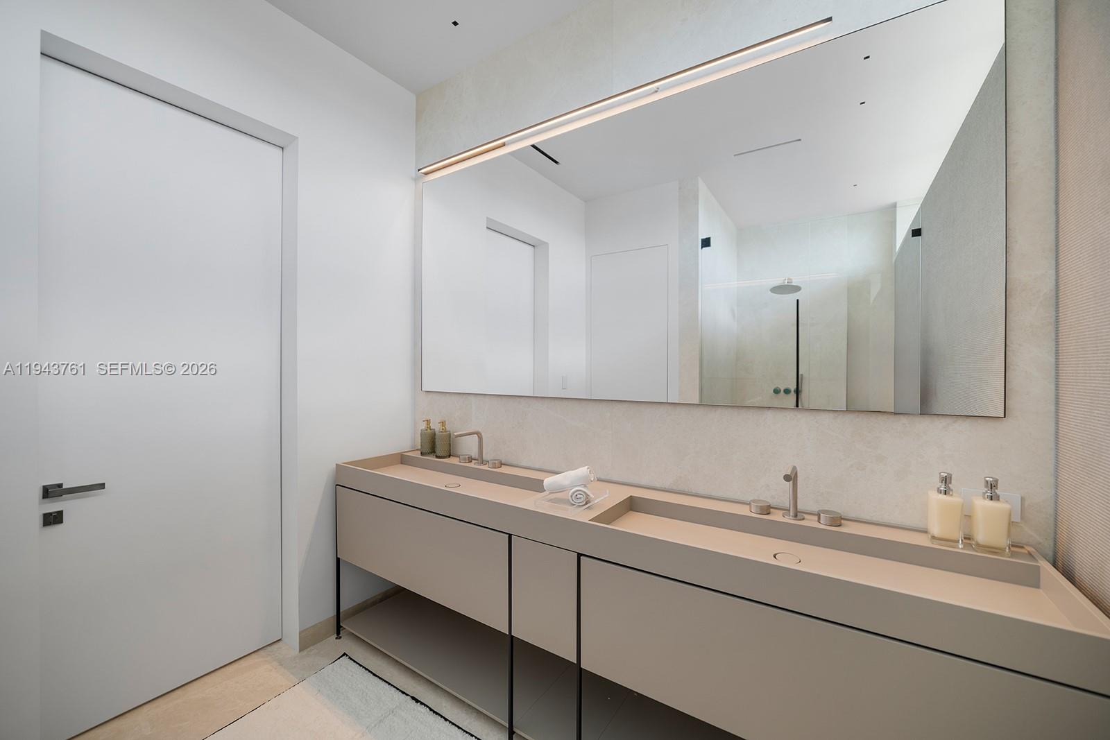 217 East Rivo Alto Drive Miami Beach, FL 33139 - Photo 31 of 87 a bathroom with a sink and a mirror