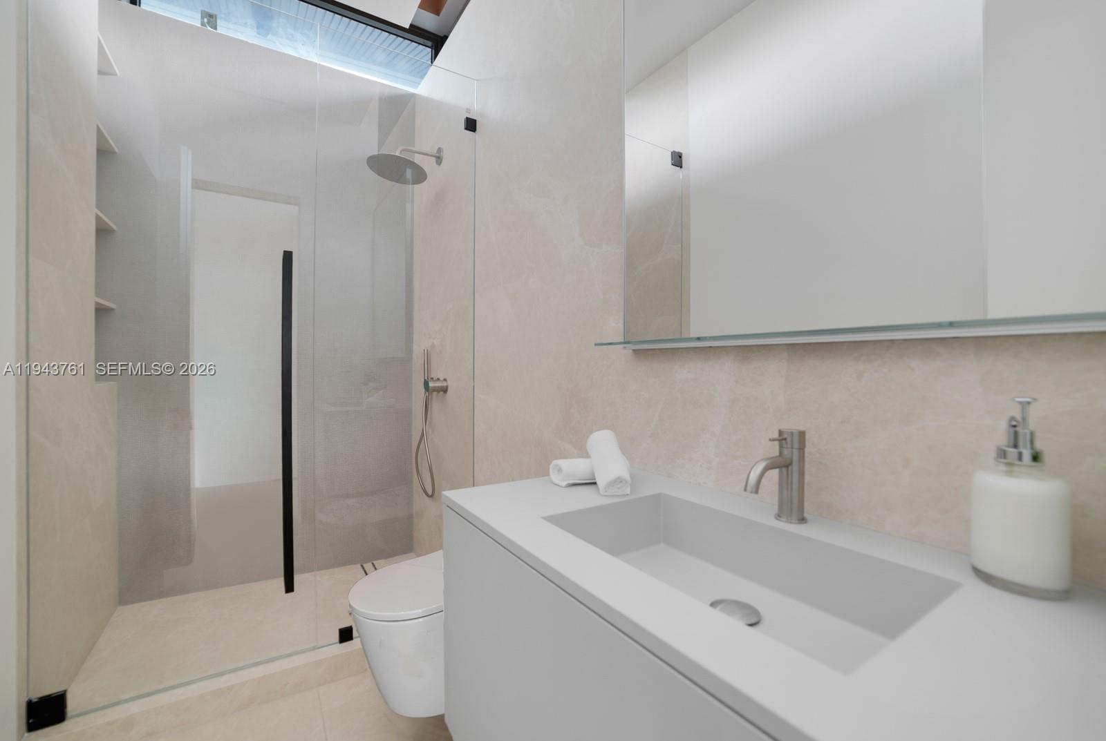 217 East Rivo Alto Drive Miami Beach, FL 33139 - Photo 41 of 87 a bathroom with a sink a toilet and shower