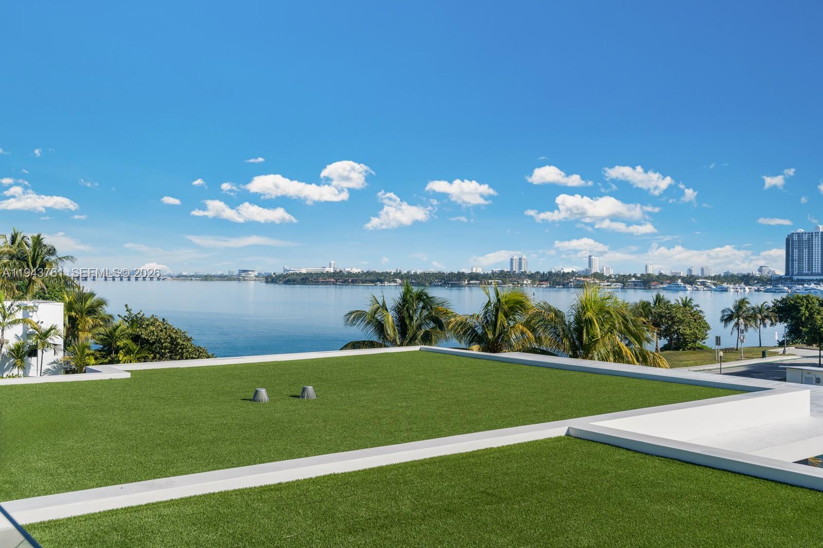 217 East Rivo Alto Drive Miami Beach, FL 33139 - Photo 52 of 87 a view of a golf course with a lake