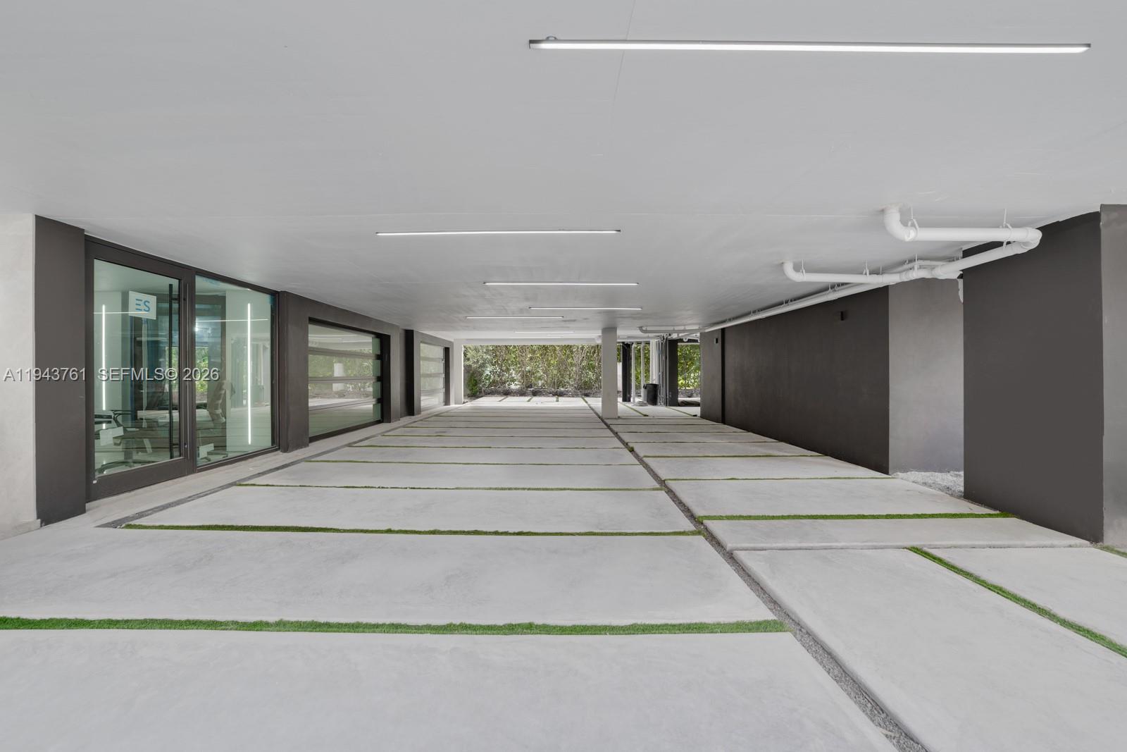 217 East Rivo Alto Drive Miami Beach, FL 33139 - Photo 58 of 87 a bedroom with a large bed and large windows