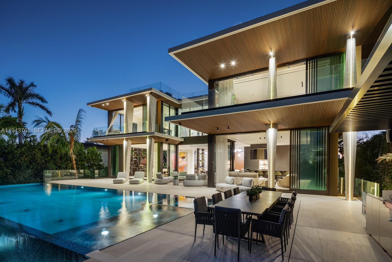 217 East Rivo Alto Drive Miami Beach, FL 33139 - Photo 73 of 87 a view of a patio with couches table and chairs with potted plants and palm trees