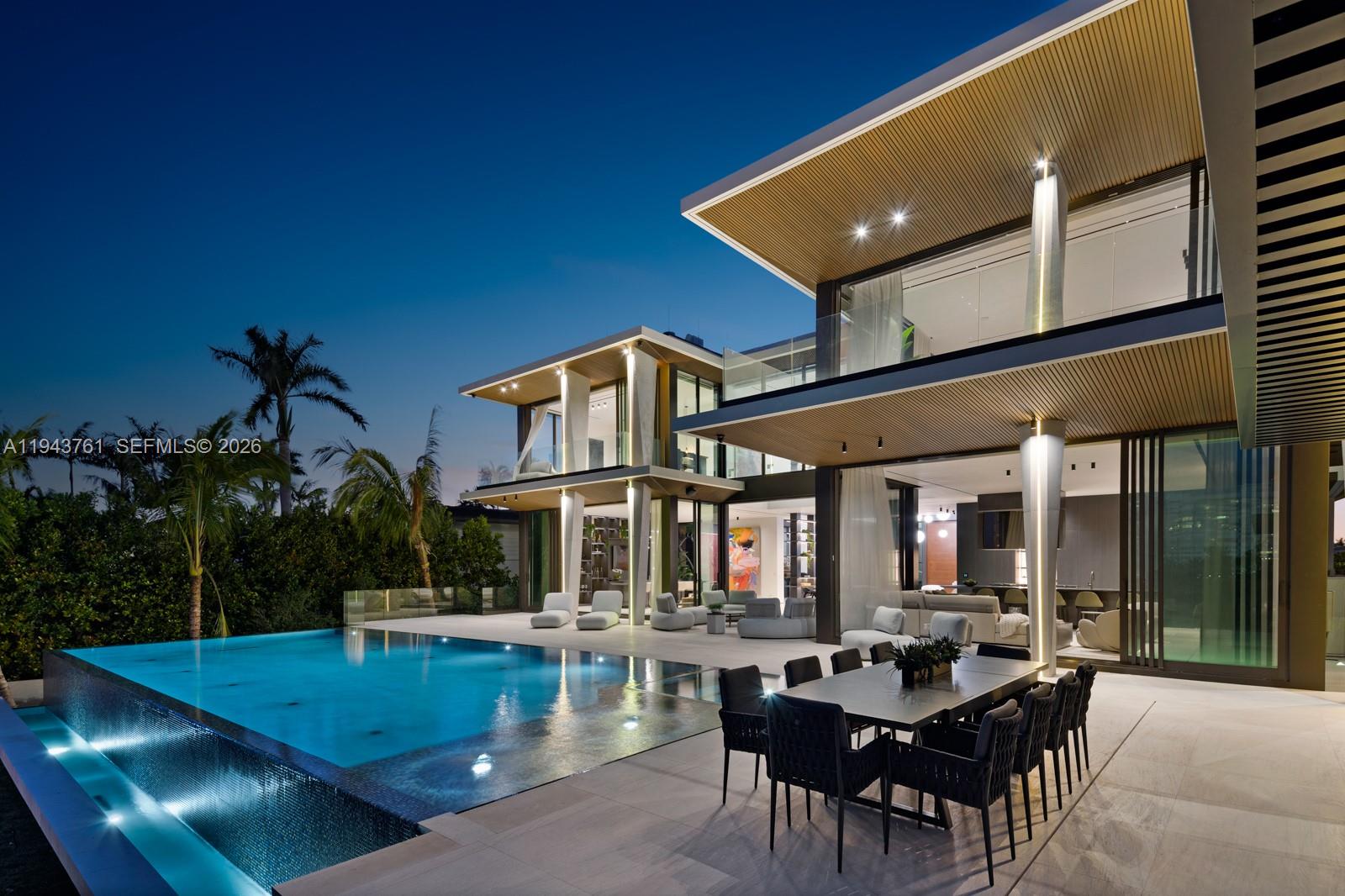 217 East Rivo Alto Drive Miami Beach, FL 33139 - Photo 77 of 87 a view of a patio with dining table and chairs with plants