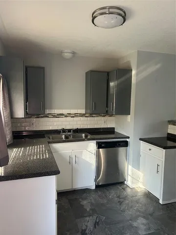 a kitchen with a sink and a refrigerator