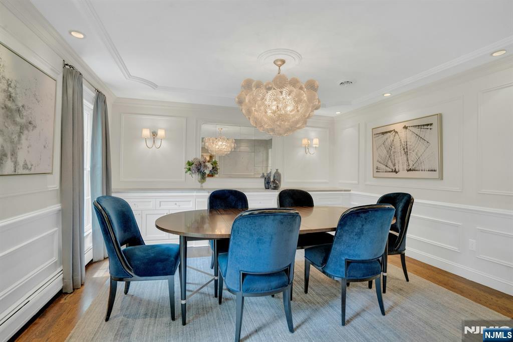 48 Hopper Farm Road Upper Saddle River, NJ 07458 - Photo 4 of 43 a view of a dining room with furniture a chandelier and wooden floor