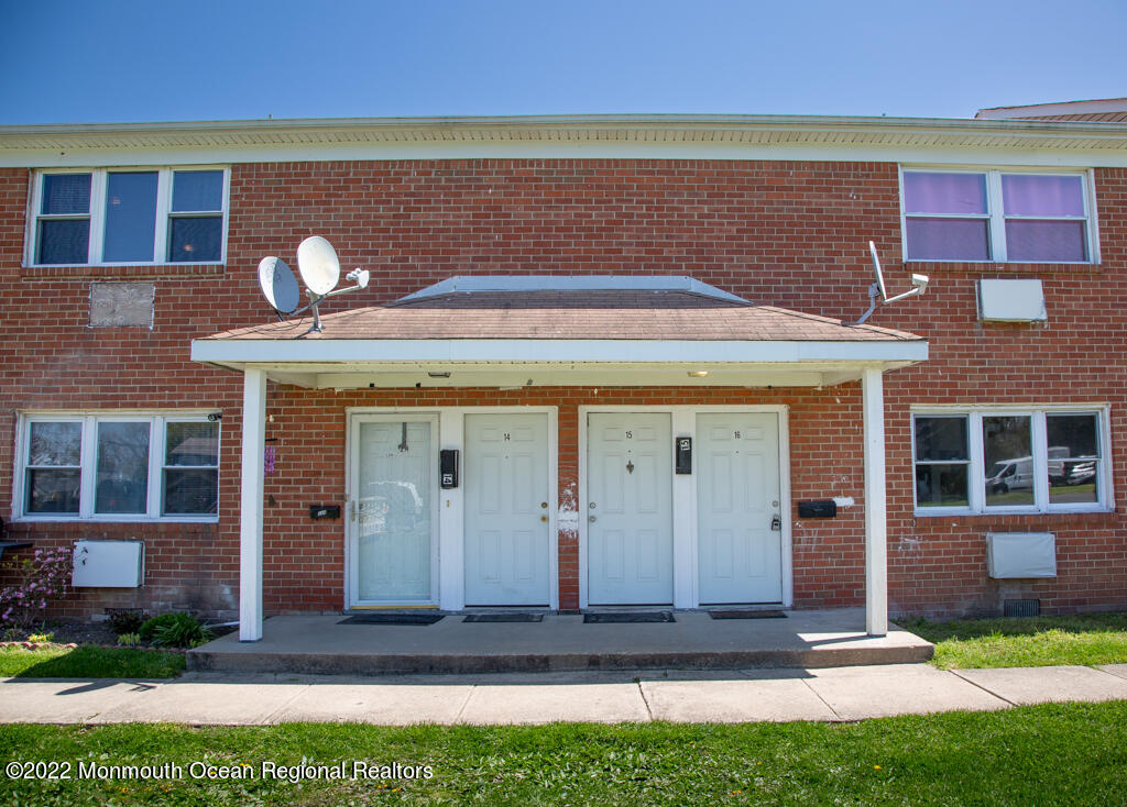 65 Steiner Avenue, Unit 11 Neptune City, NJ 07753 - Photo 1 of 3 a front view of a house with a yard