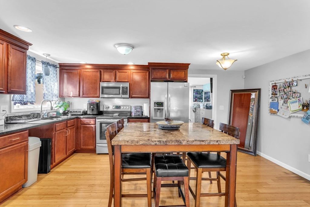 30 Fayette Street Springfield, MA 01118 - Photo 8 of 28 a kitchen with granite countertop a table chairs microwave and cabinets