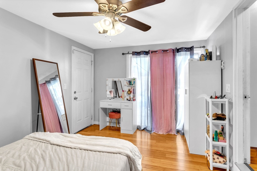 30 Fayette Street Springfield, MA 01118 - Photo 9 of 28 a bedroom with a bed and a chandelier