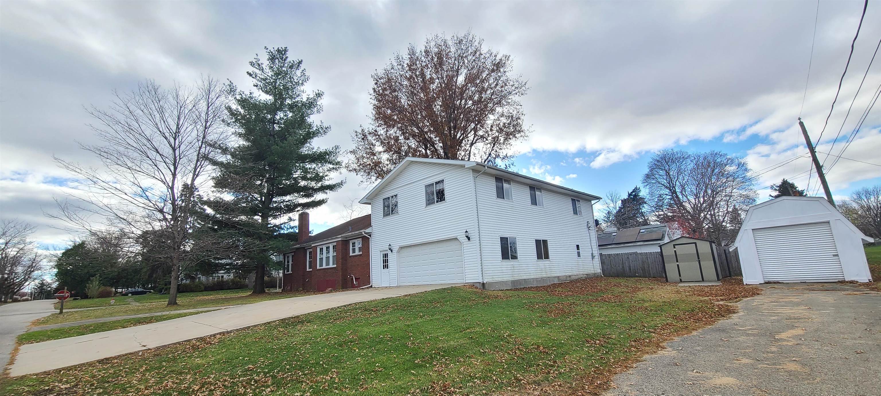 302 Sunset Lane Mount Morris, IL 61054 - Photo 45 of 47 a view of a white house next to a yard and a large tree