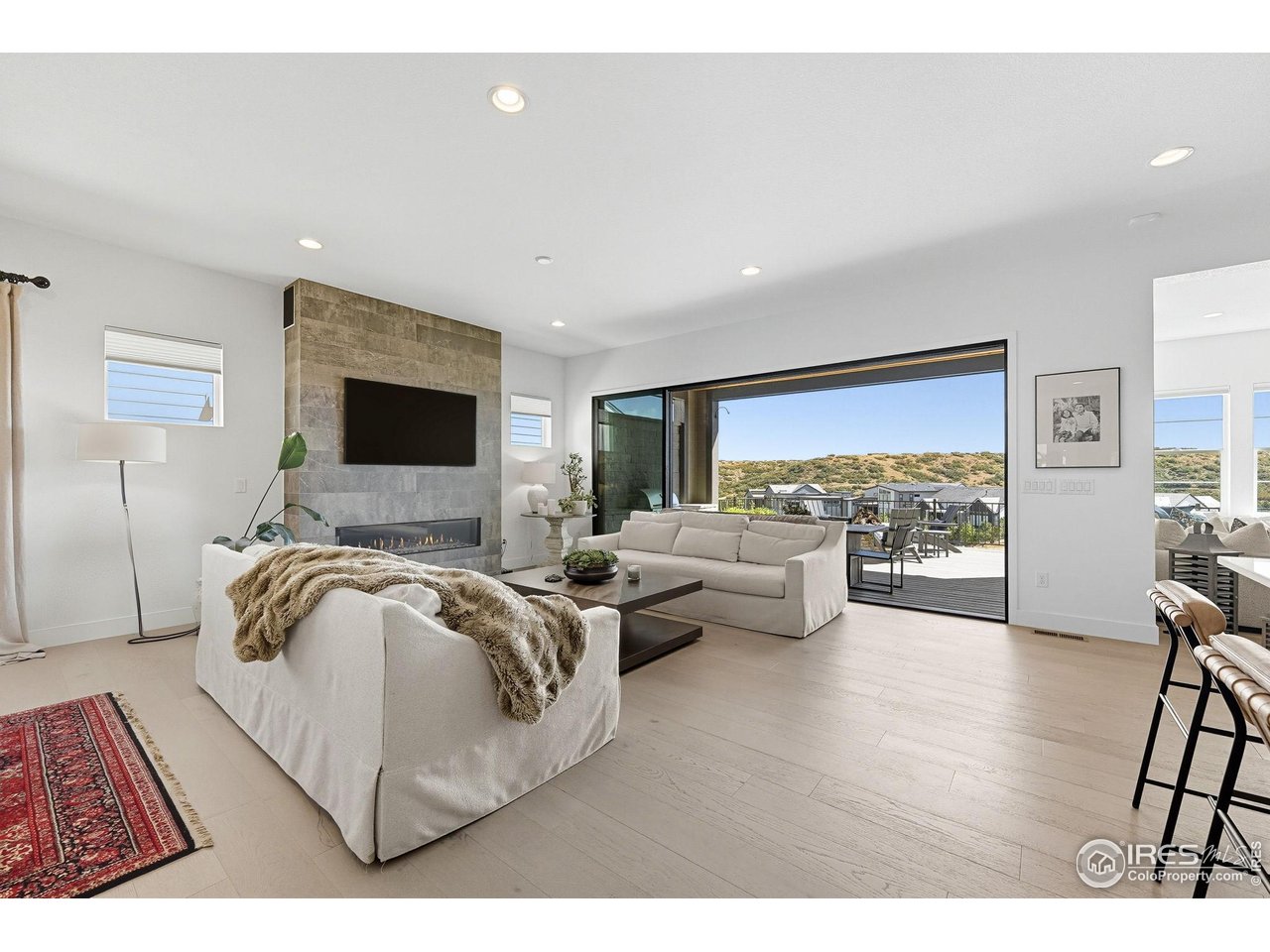 7382 Canyonpoint Road Castle Pines, CO 80108 - Photo 12 of 49 a living room with furniture and a flat screen tv