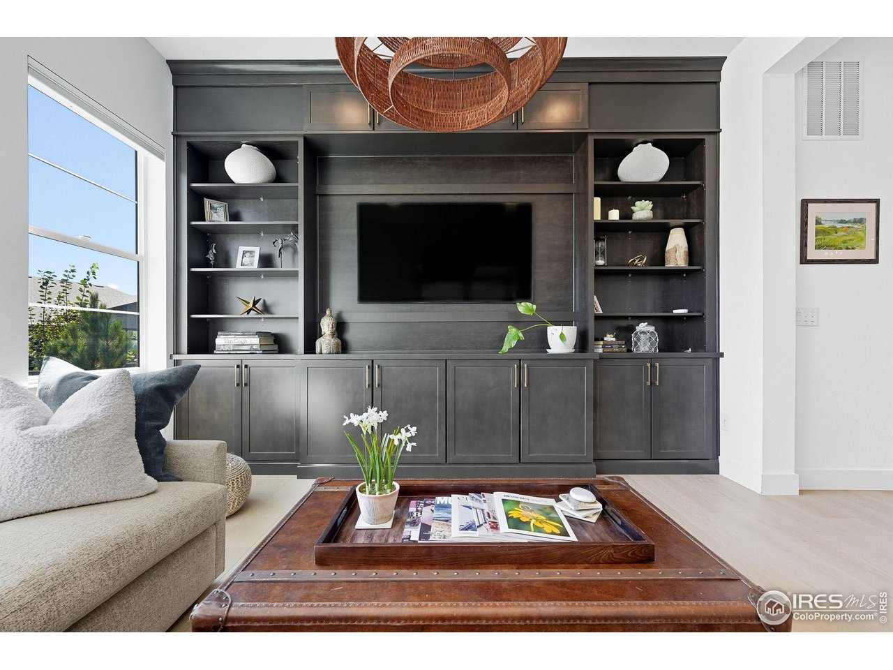 7382 Canyonpoint Road Castle Pines, CO 80108 - Photo 18 of 49 a living room with furniture a rug and a flat screen tv