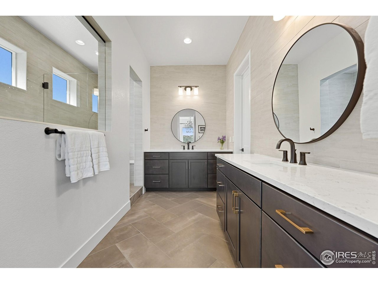 7382 Canyonpoint Road Castle Pines, CO 80108 - Photo 27 of 49 a bathroom with a sink double vanity and a mirror