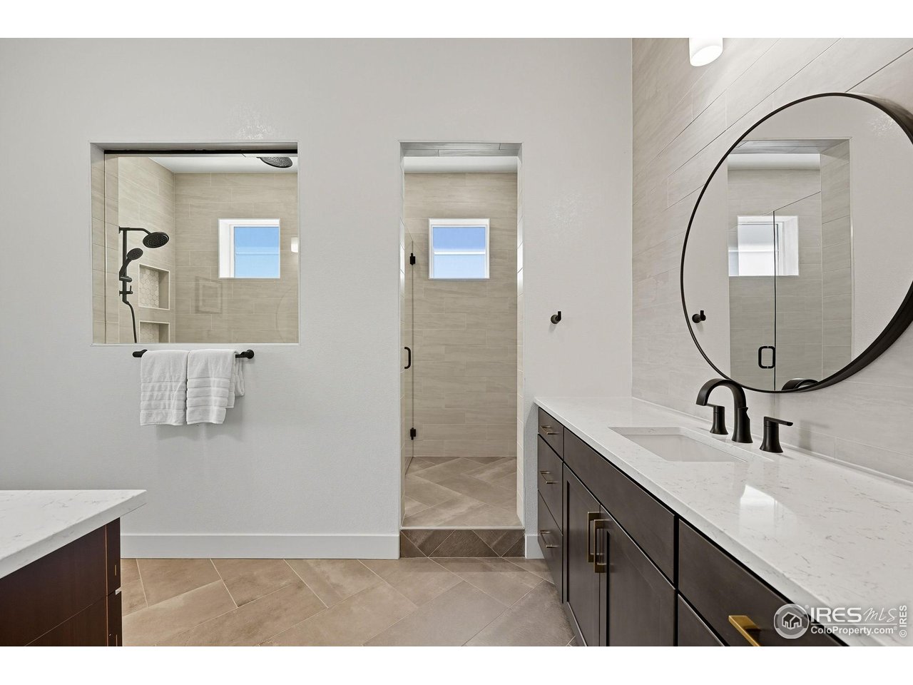 7382 Canyonpoint Road Castle Pines, CO 80108 - Photo 28 of 49 a bathroom with a sink a mirror and a shower