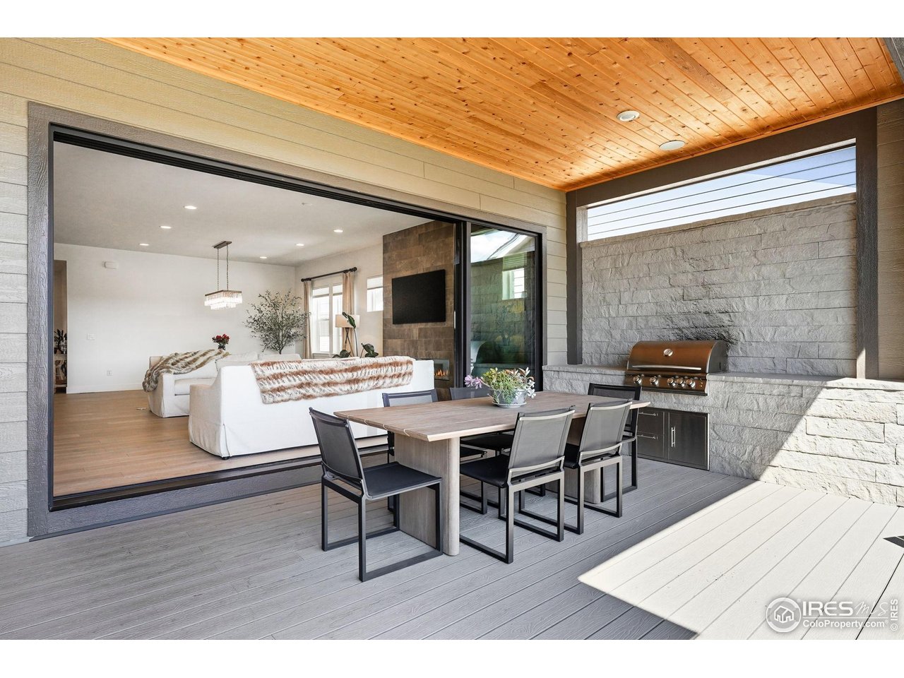 7382 Canyonpoint Road Castle Pines, CO 80108 - Photo 35 of 49 a living room with stainless steel appliances kitchen island granite countertop furniture and a wooden floor