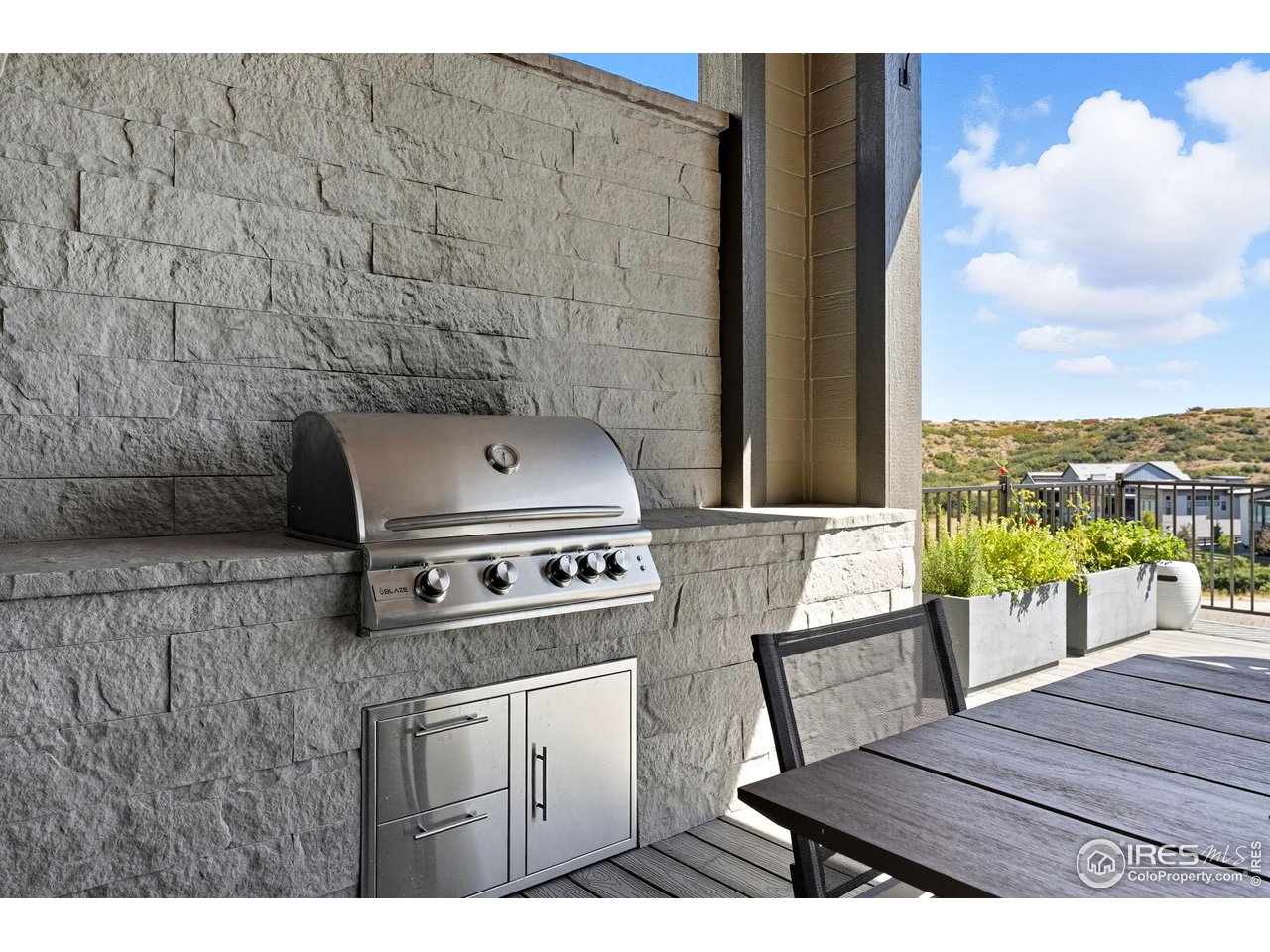 7382 Canyonpoint Road Castle Pines, CO 80108 - Photo 36 of 49 a kitchen with a table and a stove