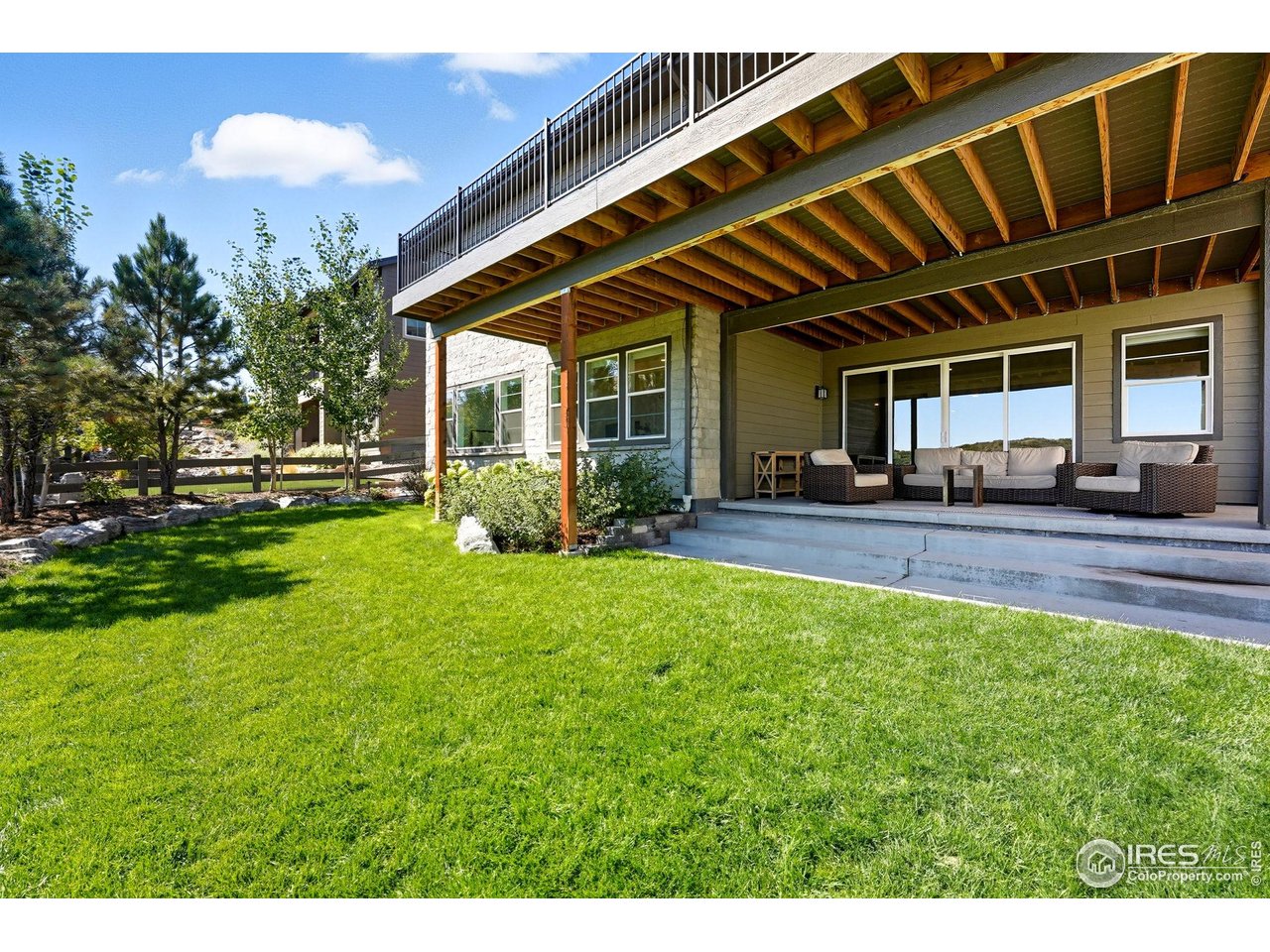 7382 Canyonpoint Road Castle Pines, CO 80108 - Photo 41 of 49 a porch with yard and outdoor seating