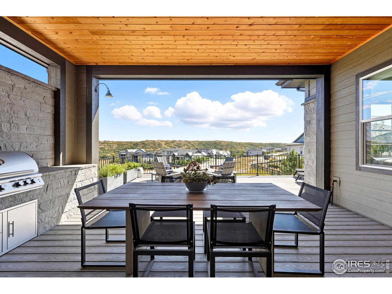 7382 Canyonpoint Road Castle Pines, CO 80108 - Photo 5 of 49 a view of a city from a dining room with furniture and window