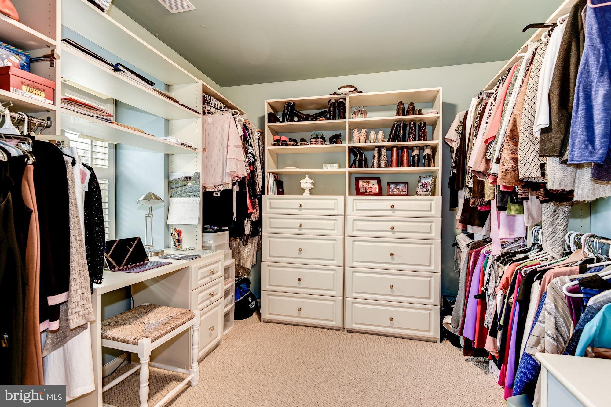 9204 Fall River Lane Potomac, MD 20854 - Photo 16 of 30 a view of walk in closet with clothes and shoes