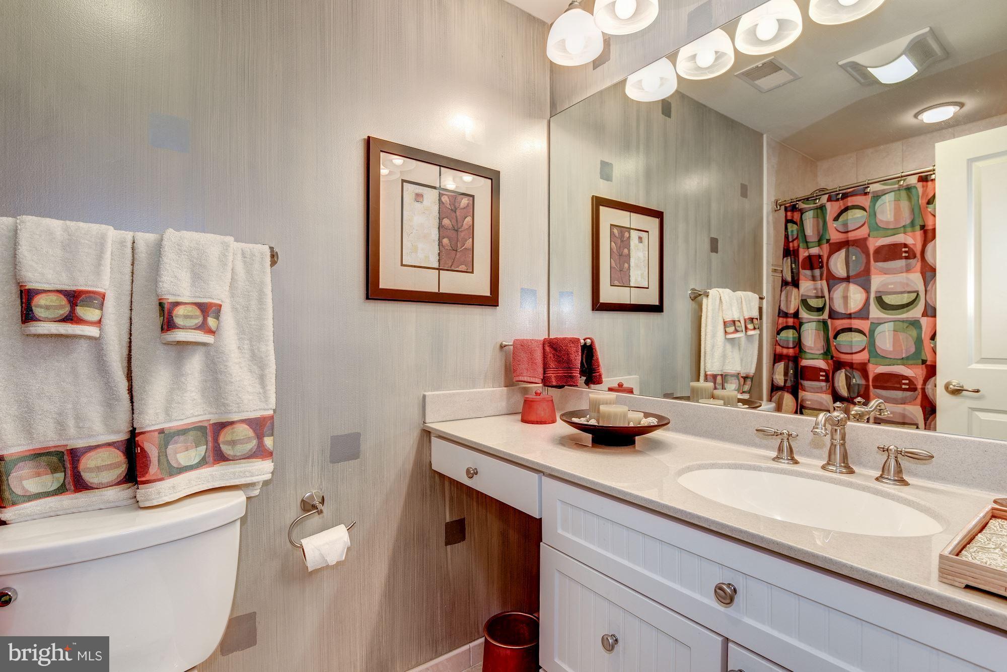 9204 Fall River Lane Potomac, MD 20854 - Photo 23 of 30 a bathroom with a granite countertop sink mirror vanity and toilet