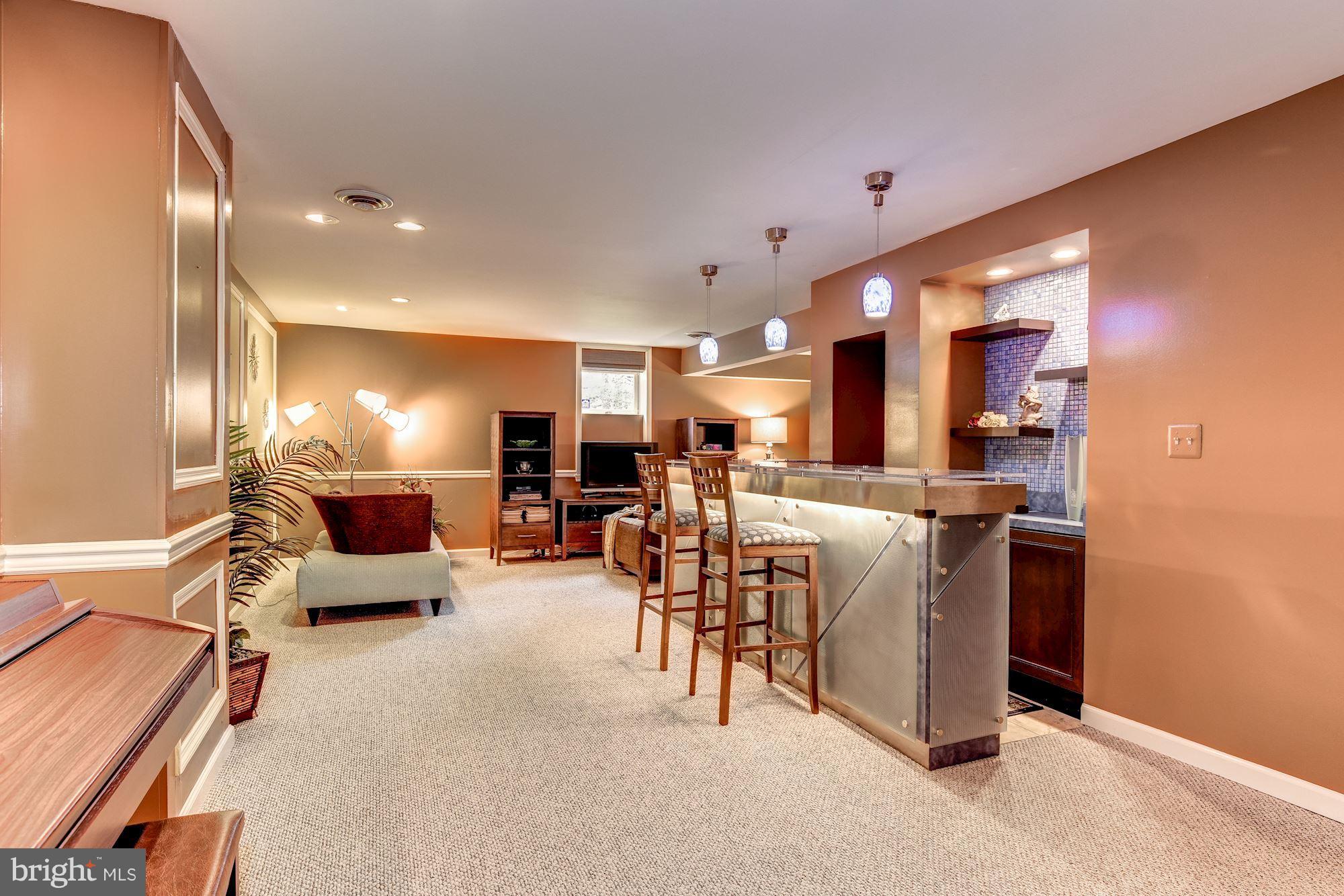 9204 Fall River Lane Potomac, MD 20854 - Photo 25 of 30 a living room with furniture and a dining table with stainless steel appliances