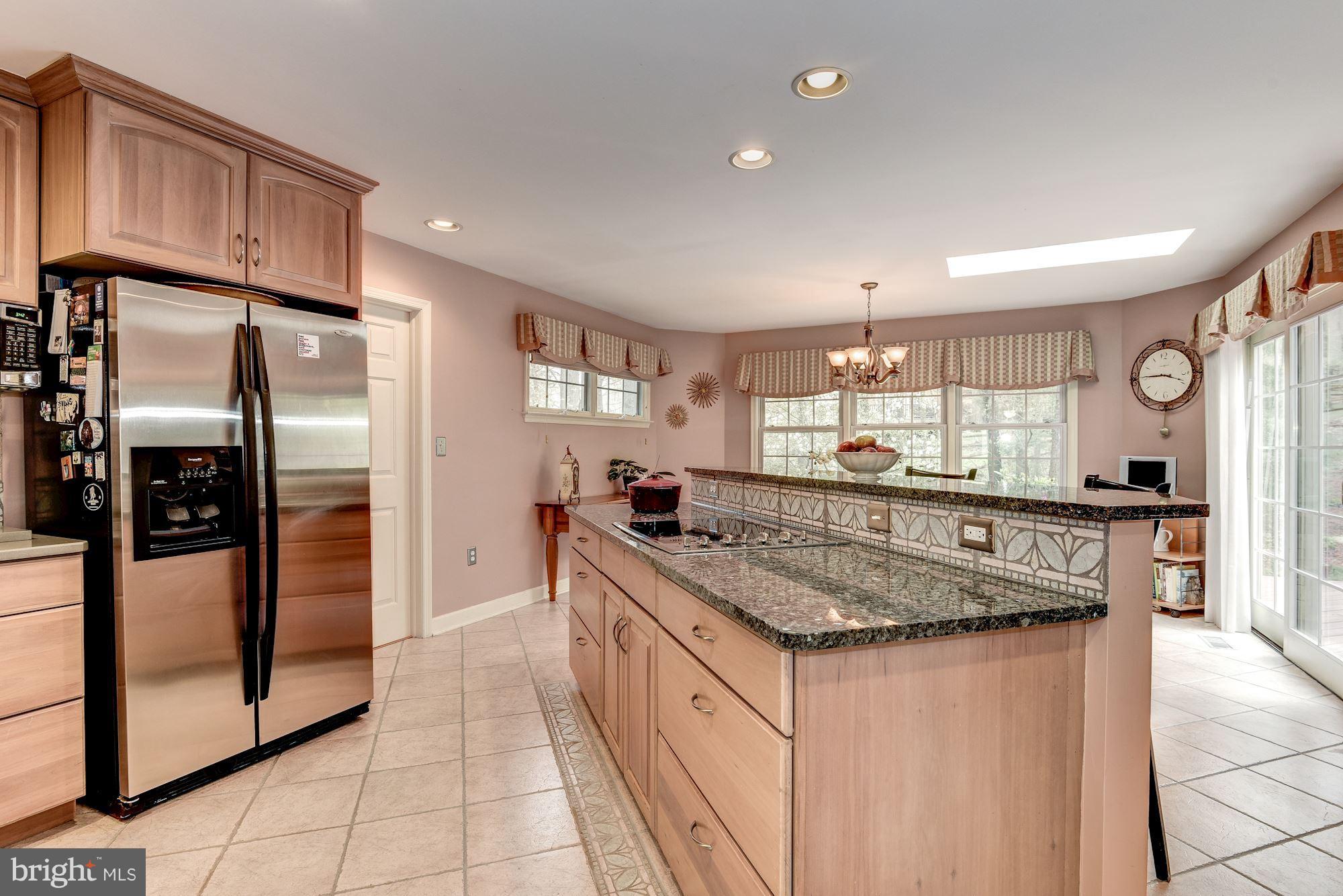 9204 Fall River Lane Potomac, MD 20854 - Photo 8 of 30 a kitchen with stainless steel appliances granite countertop a sink and a refrigerator