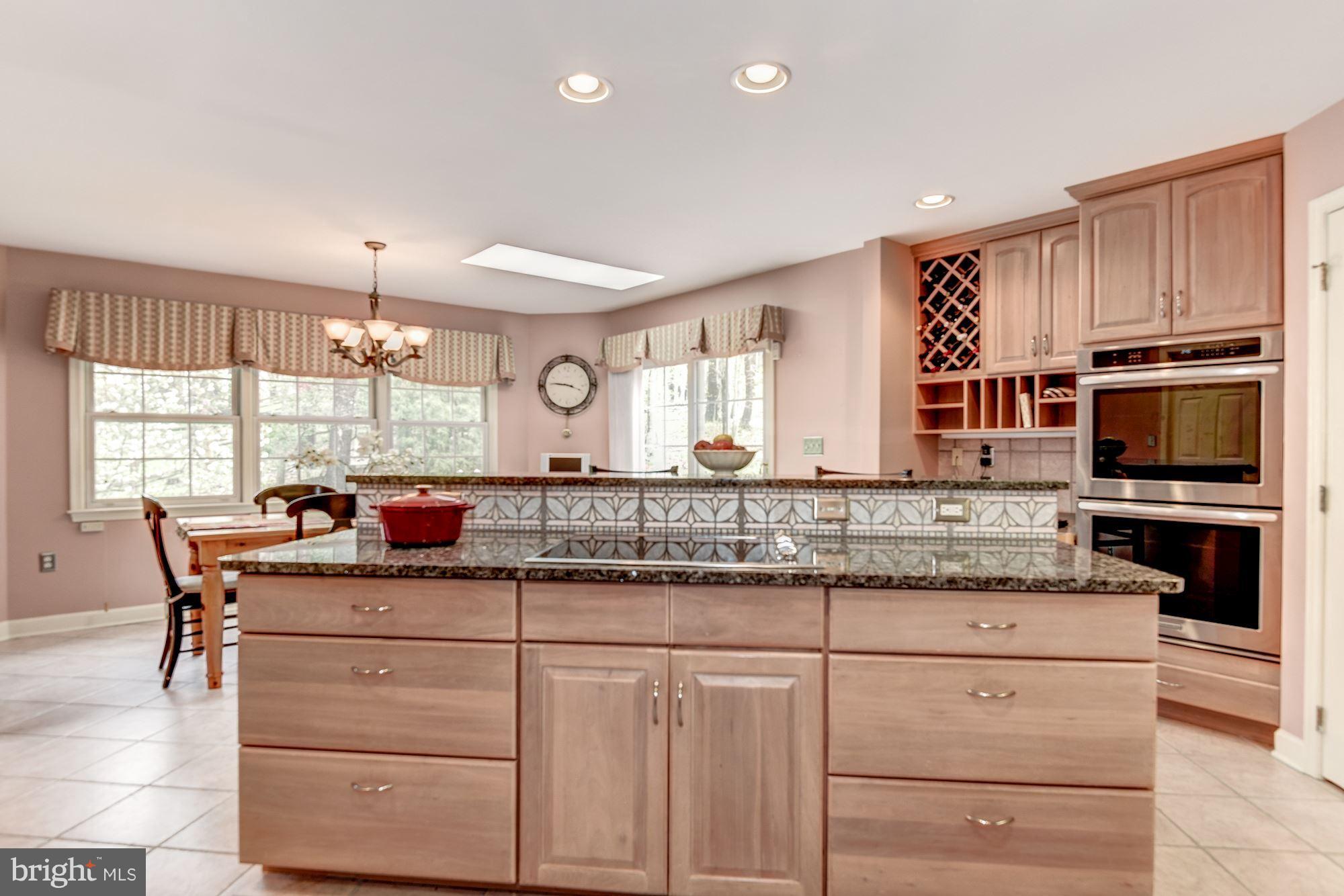 9204 Fall River Lane Potomac, MD 20854 - Photo 9 of 30 a kitchen with granite countertop cabinets stainless steel appliances and a counter space