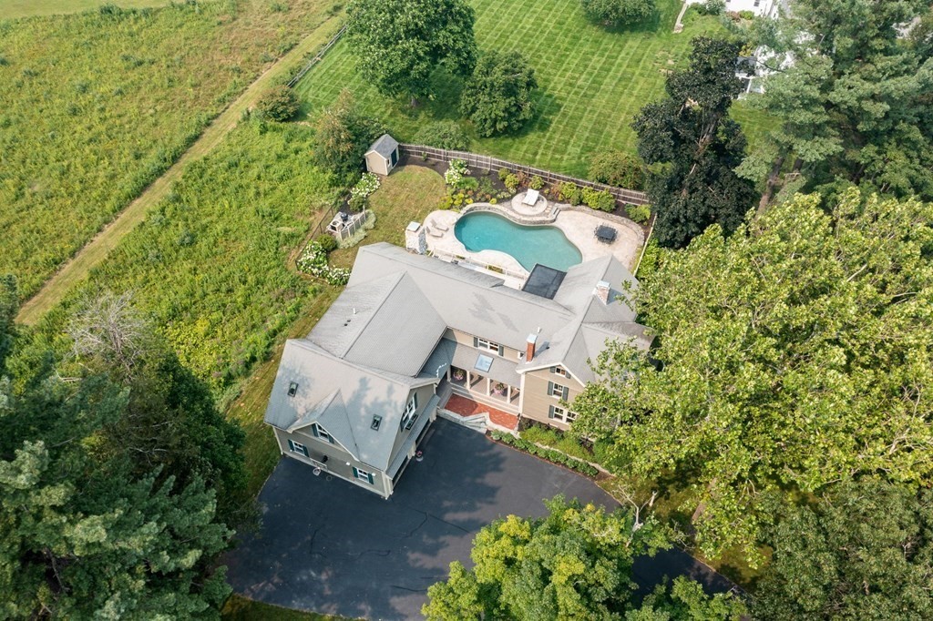 an aerial view of a house with a yard and garden