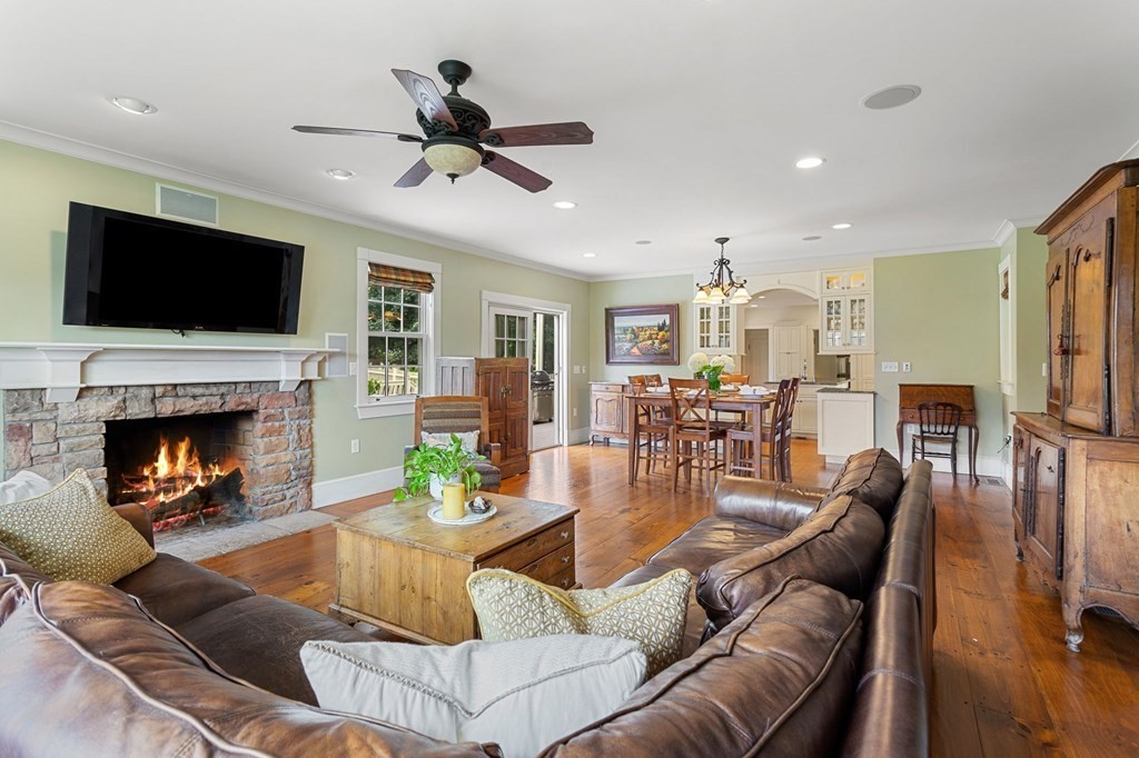 44 Old Ayer Road Groton, MA 01450 - Photo 11 of 41 a living room with furniture fireplace and a flat screen tv