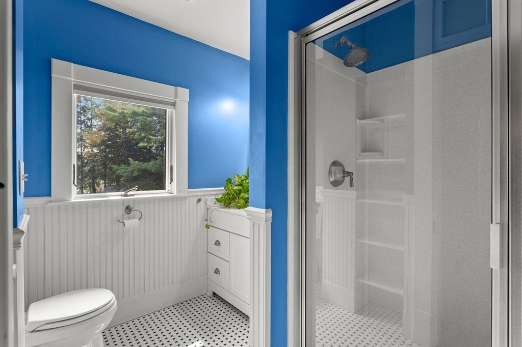 44 Old Ayer Road Groton, MA 01450 - Photo 25 of 41 a bathroom with a granite countertop sink a toilet a window and shower