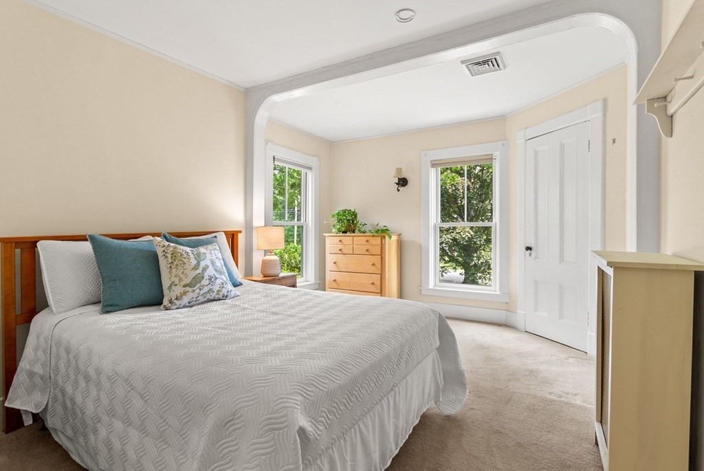 44 Old Ayer Road Groton, MA 01450 - Photo 27 of 41 a large bed sitting in a bedroom next to a window