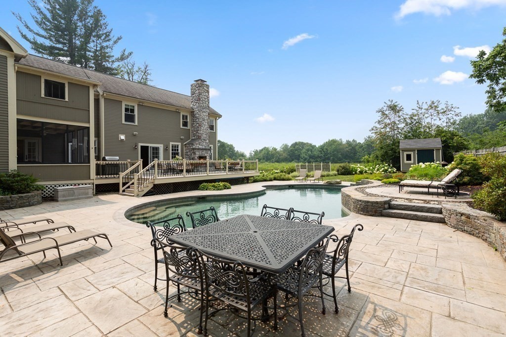 44 Old Ayer Road Groton, MA 01450 - Photo 3 of 41 a view of house with patio outdoor seating and city view