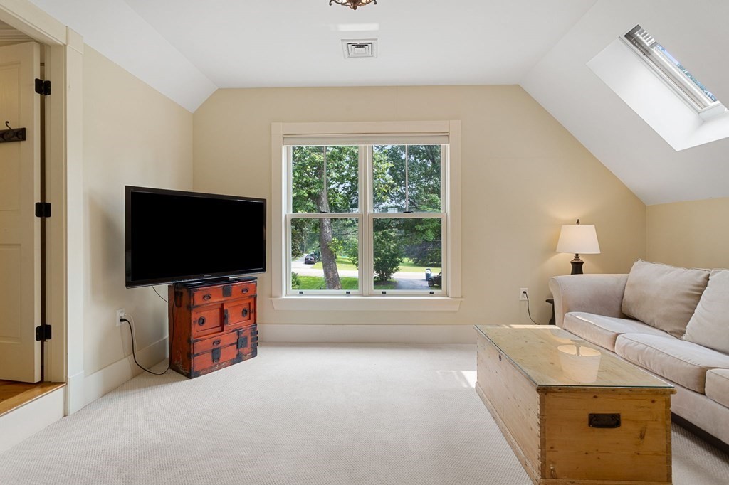 44 Old Ayer Road Groton, MA 01450 - Photo 31 of 41 a living room with furniture and a flat screen tv