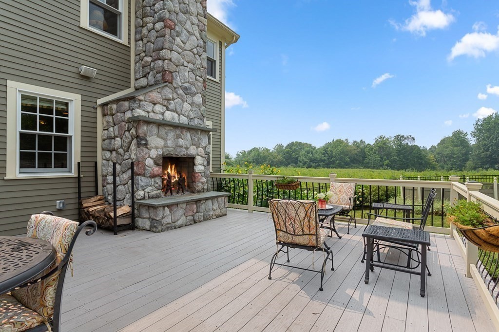 44 Old Ayer Road Groton, MA 01450 - Photo 4 of 41 a balcony with furniture and a fireplace