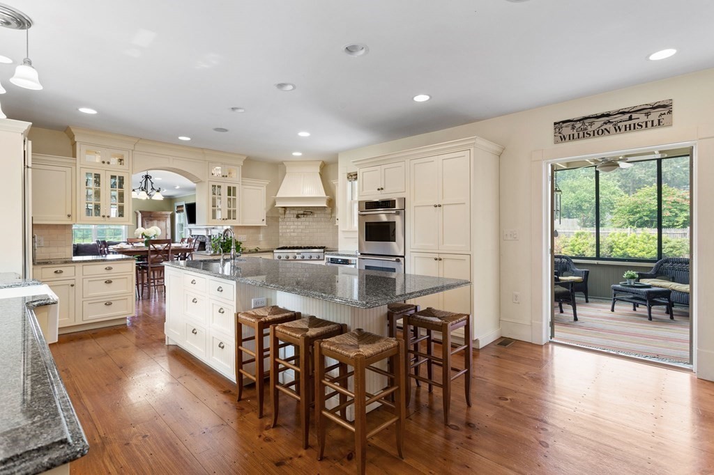 44 Old Ayer Road Groton, MA 01450 - Photo 9 of 41 a kitchen with white cabinets and wooden floor