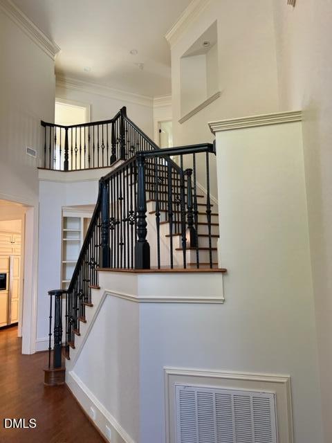 3316 Darien Drive Raleigh, NC 27607 - Photo 3 of 30 a view of staircase with lots of frames on wall and a window