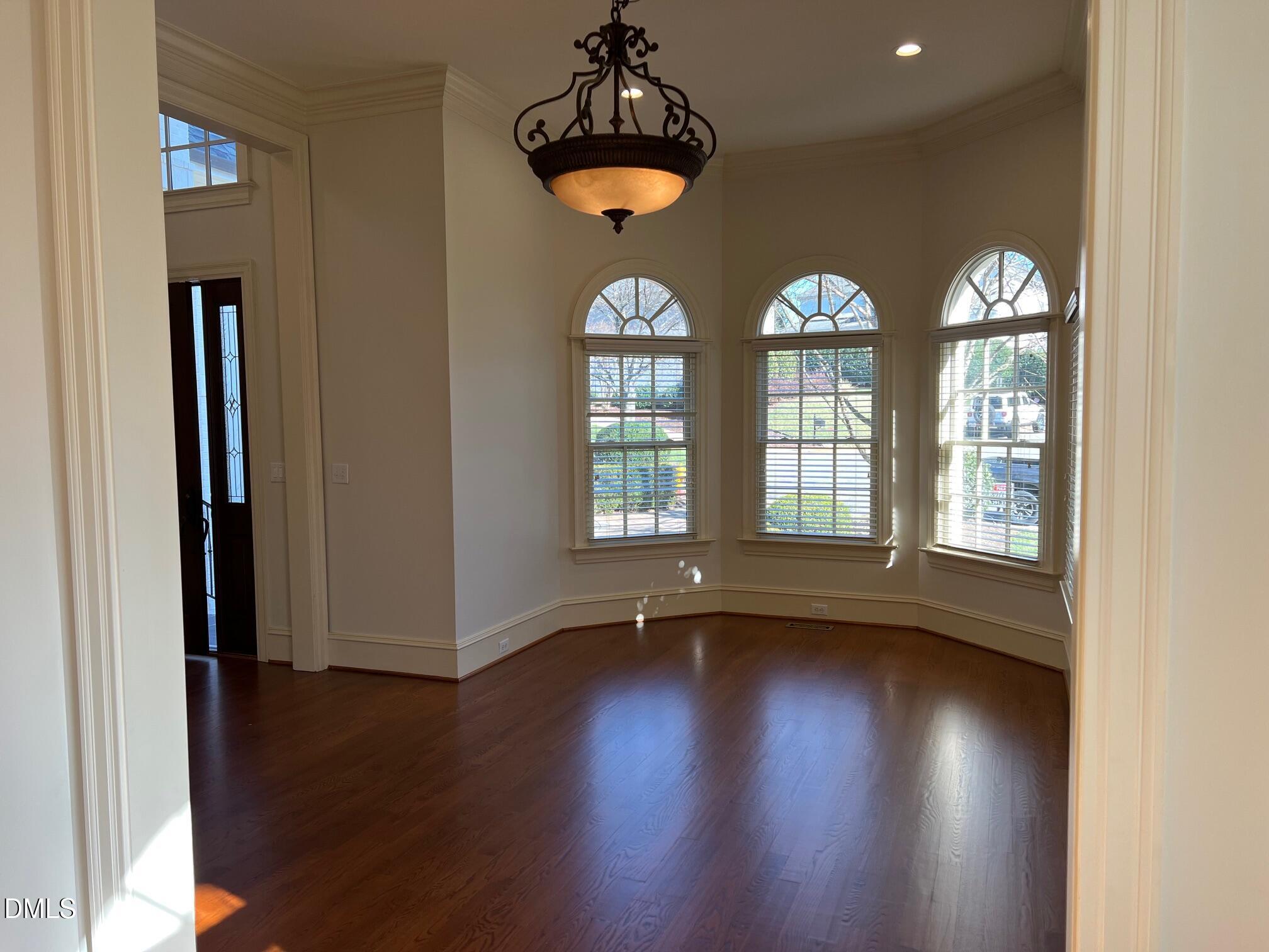 3316 Darien Drive Raleigh, NC 27607 - Photo 9 of 30 a view of an empty room with wooden floor and a window