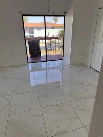 a view of an empty room with a glass door