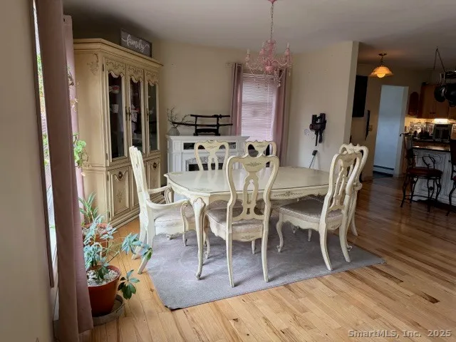 a view of a dining room with furniture wooden floor and a chandelier