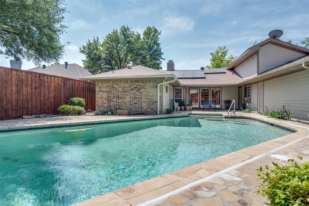 a view of a house with a yard and sitting area