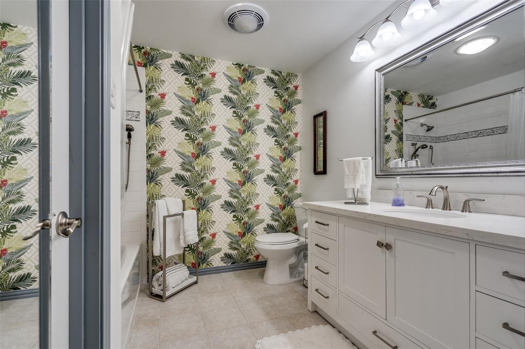 7115 Duffield Drive Dallas, TX 75248 - Photo 16 of 25 a bathroom with a sink and a mirror