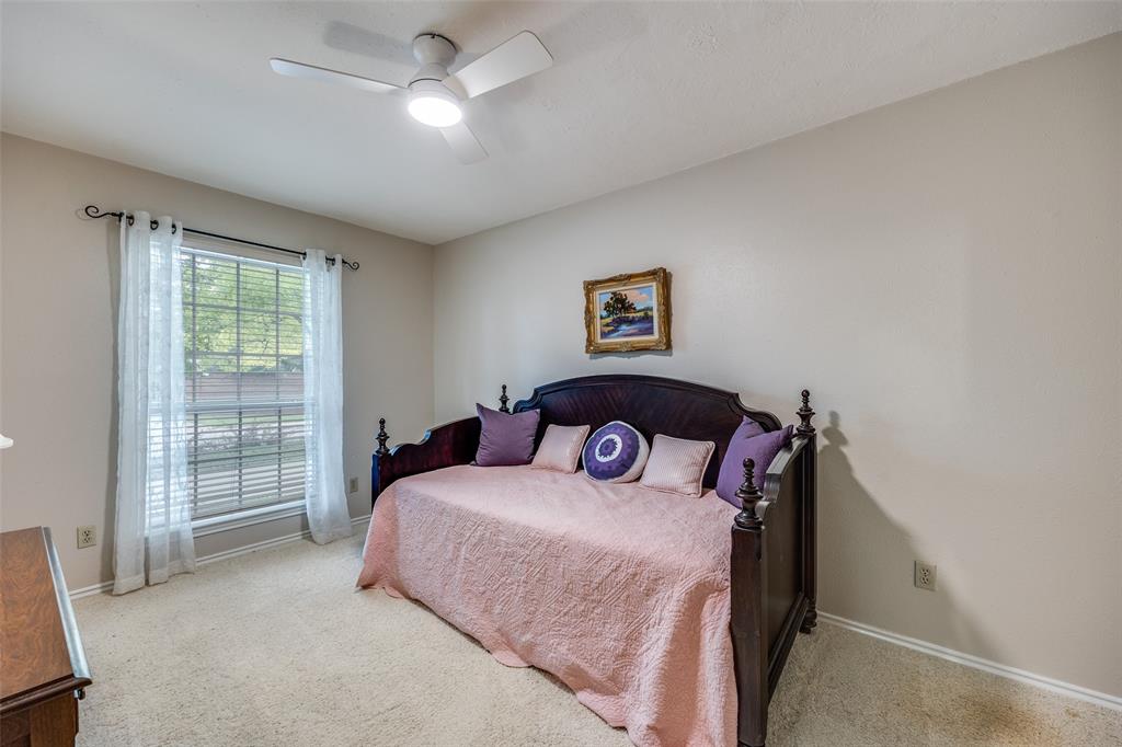 7115 Duffield Drive Dallas, TX 75248 - Photo 18 of 25 a bedroom with a bed and a window