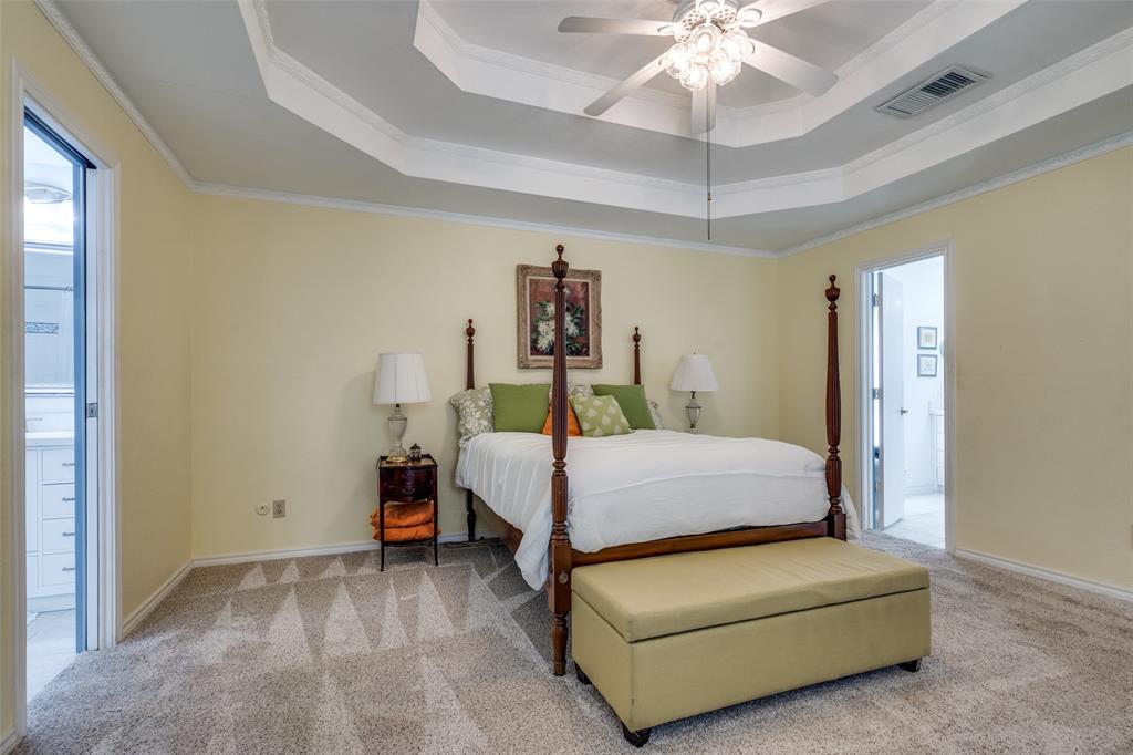 7115 Duffield Drive Dallas, TX 75248 - Photo 4 of 25 a bed room with a bed and a ceiling fan