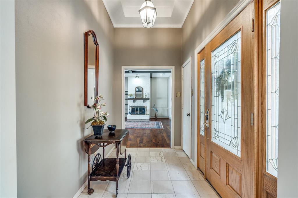 7115 Duffield Drive Dallas, TX 75248 - Photo 6 of 25 a view of a hallway with furniture and a chandelier