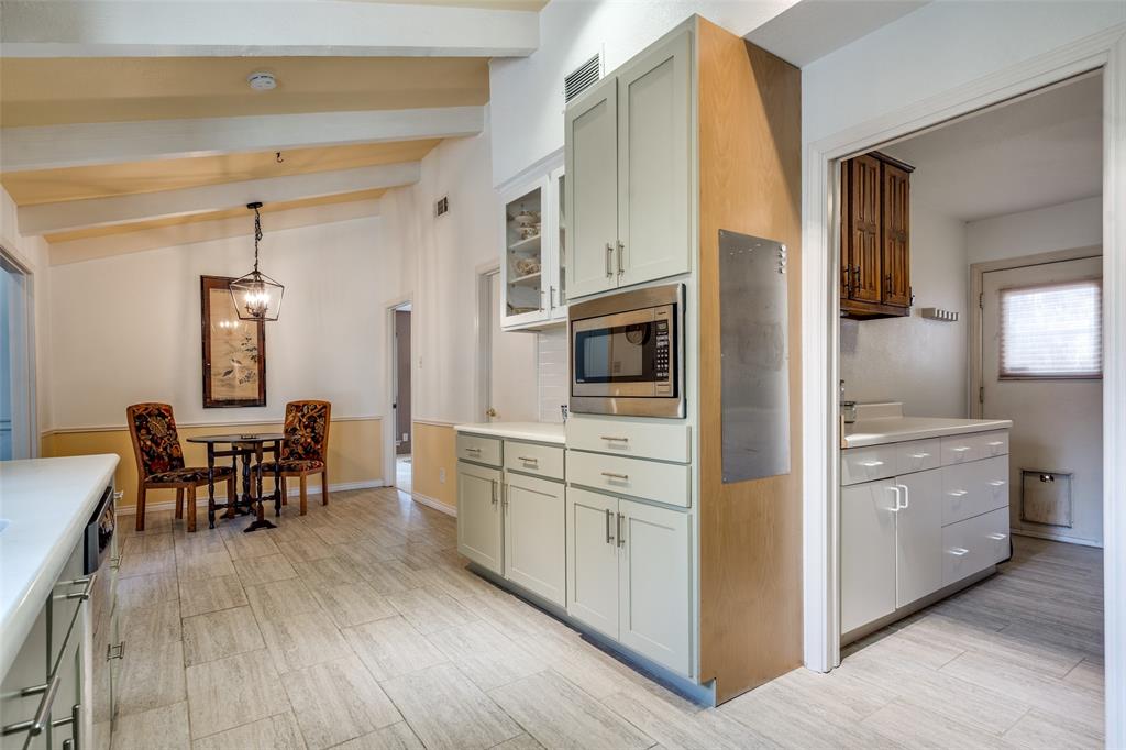 7115 Duffield Drive Dallas, TX 75248 - Photo 10 of 25 a kitchen with stainless steel appliances granite countertop a stove and a refrigerator