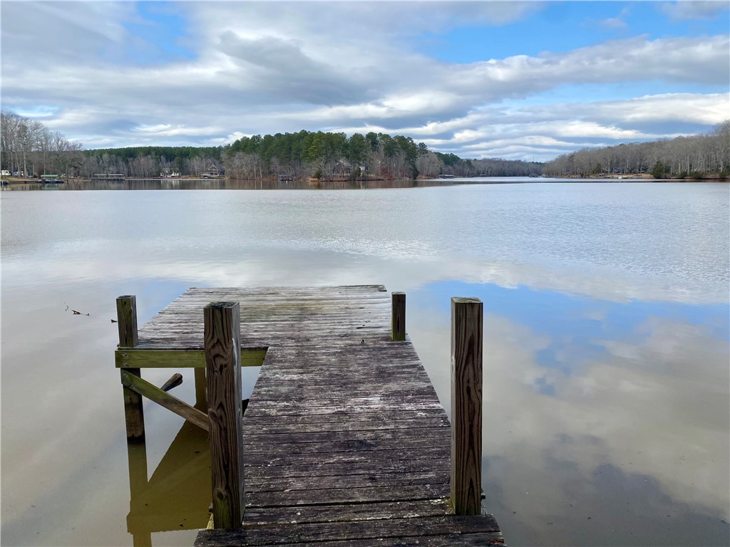 Tr6 Pierce And Amy Road Iva, SC 29655 - Photo 4 of 21 A tranquil lake view with a private pier extending into calm waters, reflecting the open sky.
