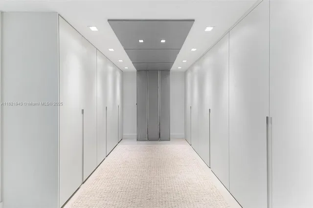 a bathroom with a tub a sink and mirrors