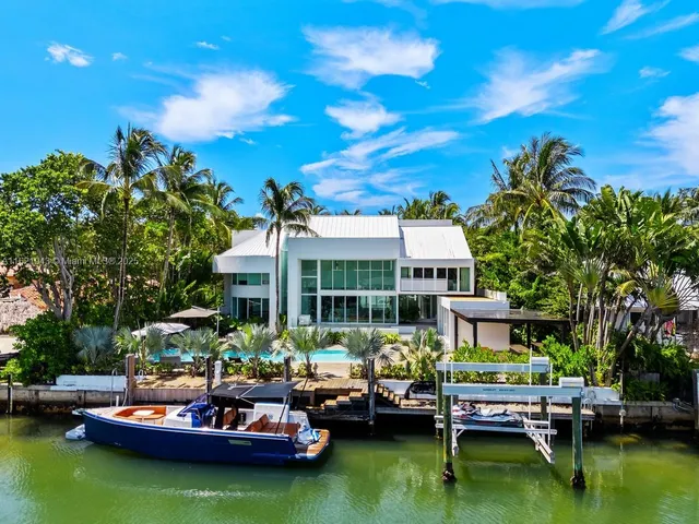 an aerial view of a house with swimming pool patio and outdoor seating